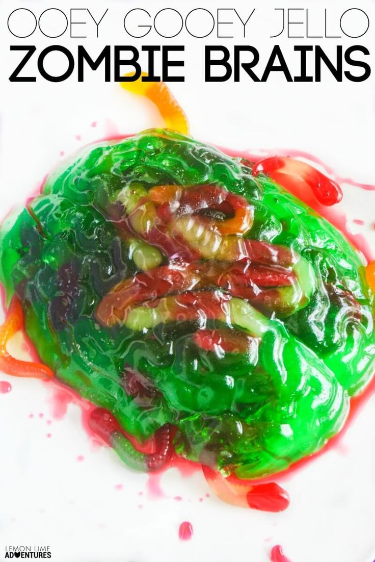 a close up of a plate of food with jelly beans on it and the words, gooey gooey jello zombie brains