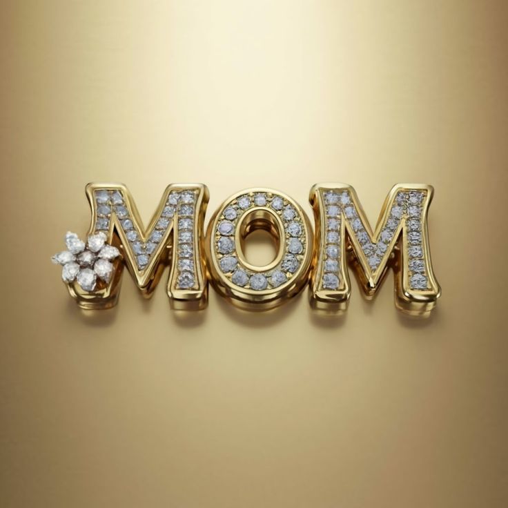 the word mom written in gold letters with diamonds on it and a flower at the bottom