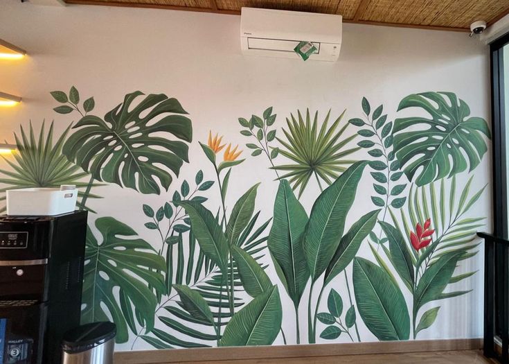 a wall mural with tropical leaves and flowers on it's side in a kitchen