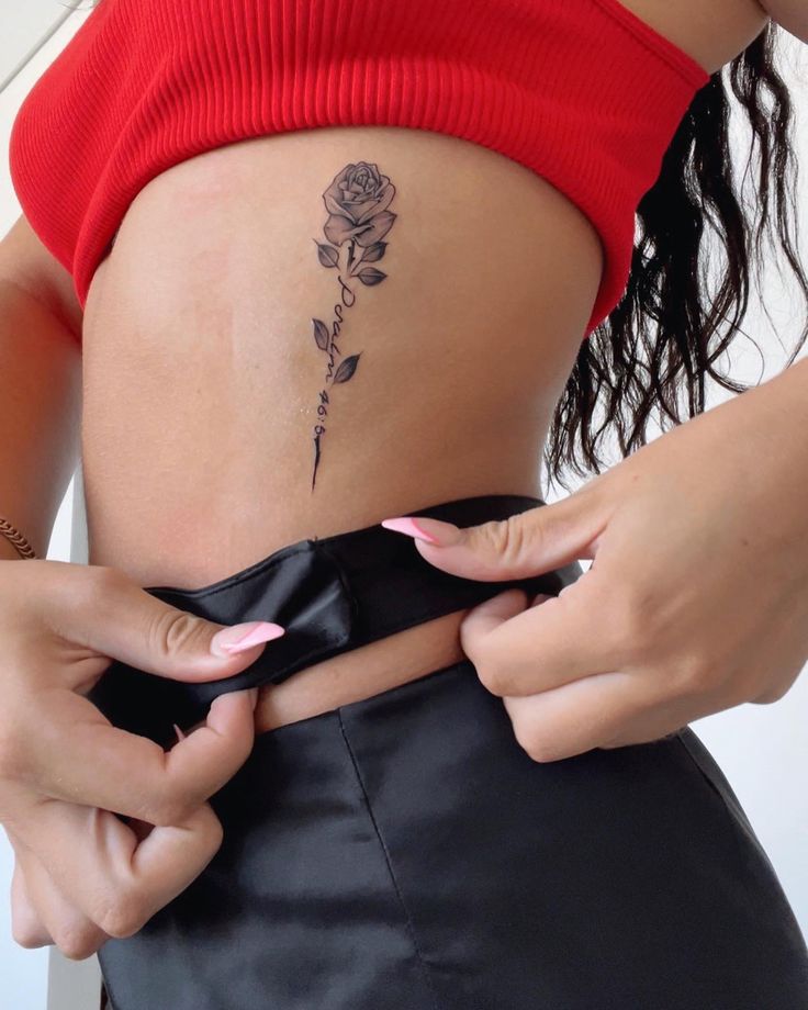 Psalm 46:5 on ribs. Detailed rose tattoo. Rose With Bible Verse Tattoo, Rose Tattoos Ribs, Rose Side Rib Tattoo, Rose Bible Verse Tattoo, Bible Verse Tattoo With Cross, Cute Tattoos On Ribs, Name In A Rose Tattoo, Rib Rose Tattoos For Women, Bible Verse Tattoos On Ribs