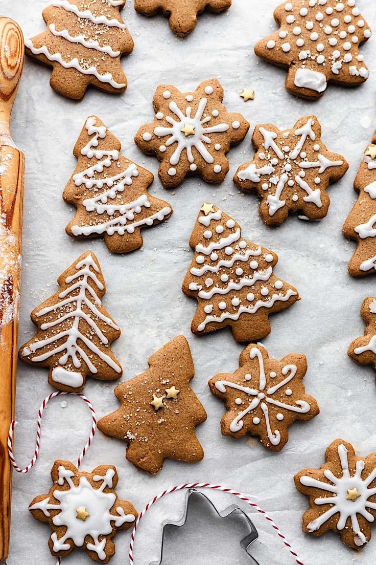 gingerbread cookies decorated with icing and sprinkles on a baking sheet