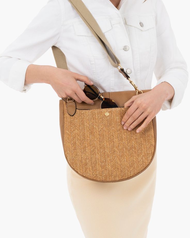 A chic messenger bag crafted from woven raffia straw; Palm Pouch has a bevel curved leather bottom with top flap closure. This user-friendly bag has pockets galore, including two outer ones, one of which is discreetly placed under the flap. An adjustable crossbody strap of cotton twill makes Palm Pouch the perfect travel bag, leaving both hands free. Inside: Palm Pouch has a canvas lining, sidewall zip compartment and a roomy patch pocket. Height: 11", length: 11”, width: 3” Woven synthetic raff Natural Satchel Straw Bag For On-the-go, Luxury Woven Bags For On-the-go, Natural Woven Shoulder Bag For Errands, Natural Straw Bag With Adjustable Strap For On-the-go, Beige Woven Straw Bag For Errands, Everyday Woven Crossbody Satchel, Beige Woven Leather Crossbody Straw Bag, Modern Woven Hobo Travel Bag, Modern Straw Shoulder Bag With Braided Handles