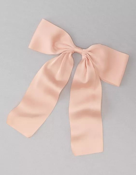 a pink bow on top of a white table