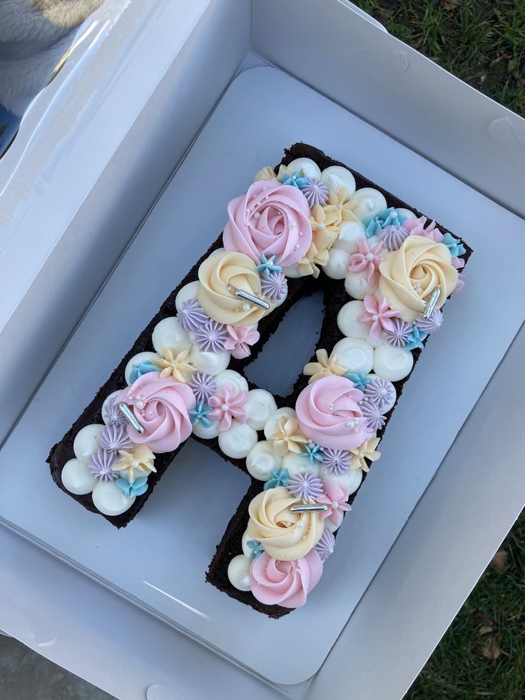 the letter h is decorated with flowers and icing