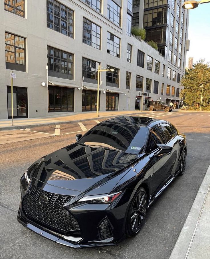 a black sports car parked on the side of the road in front of some buildings