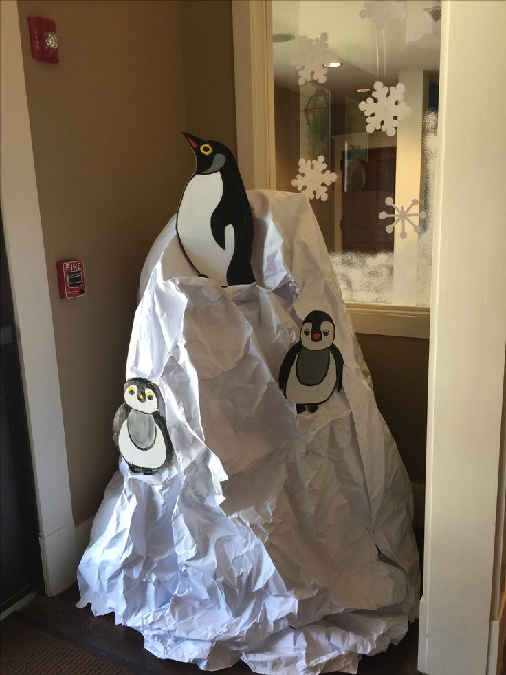 there is a paper bag with some penguins on it and another penguin in the background