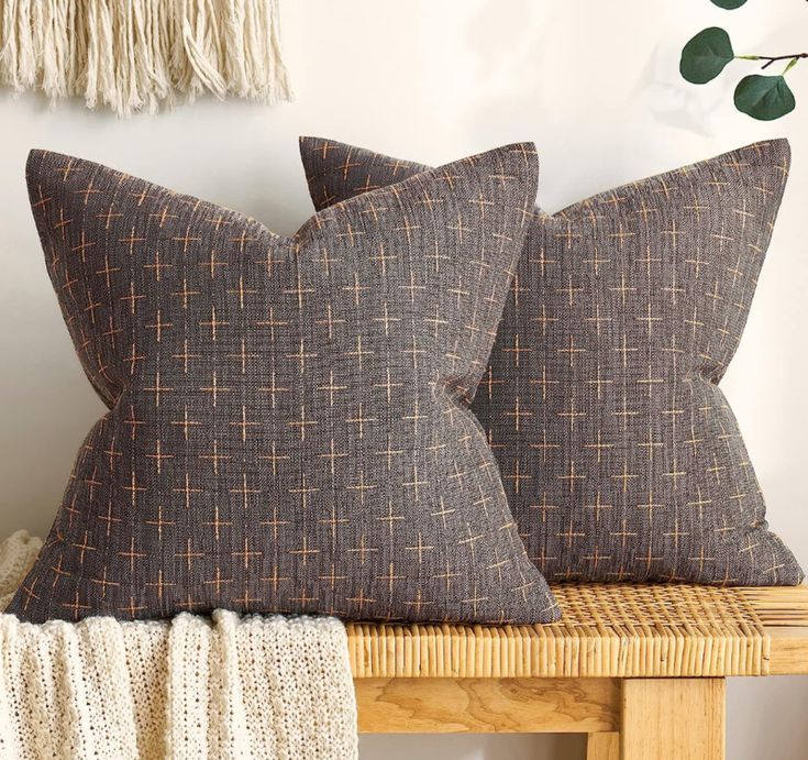 two brown pillows sitting on top of a wooden table