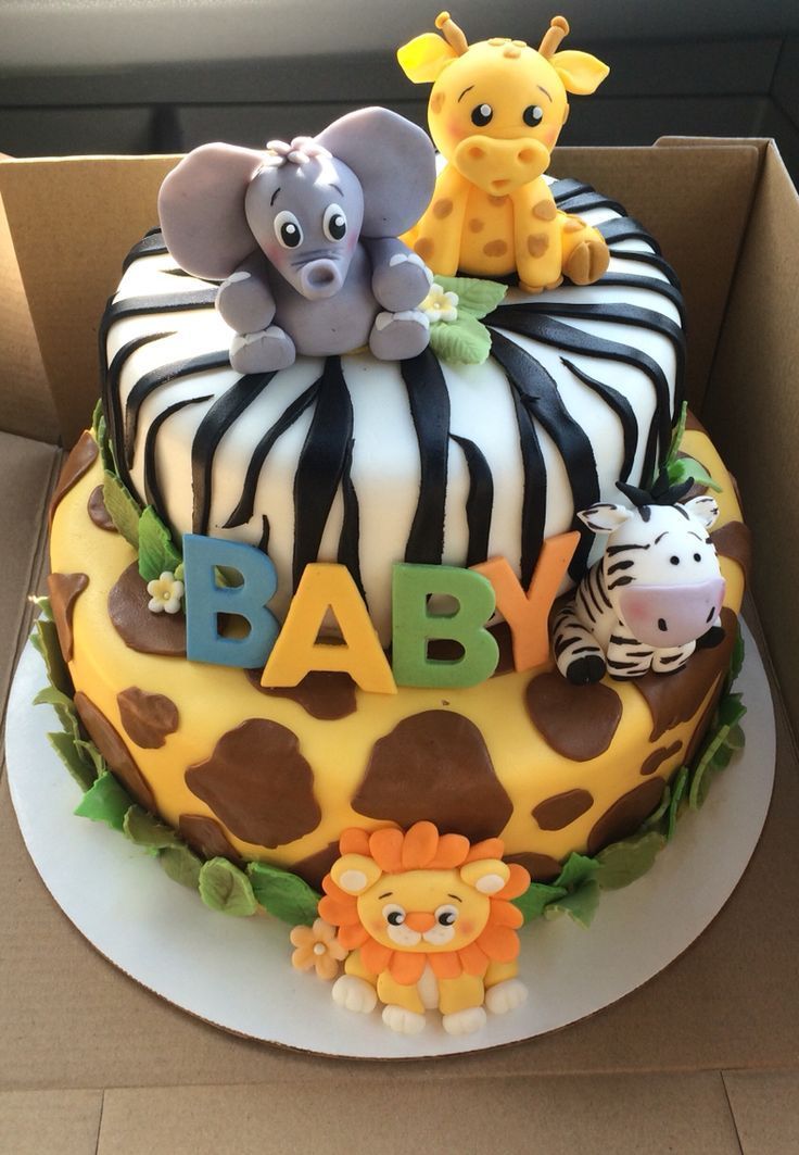 a baby shower cake decorated with animals and zebras