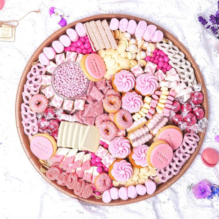 a platter filled with lots of different types of cookies and candies on top of a table