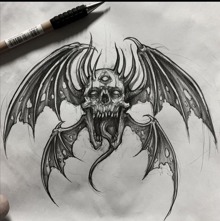 a drawing of a demon skull with wings on it's head and fangs in the mouth