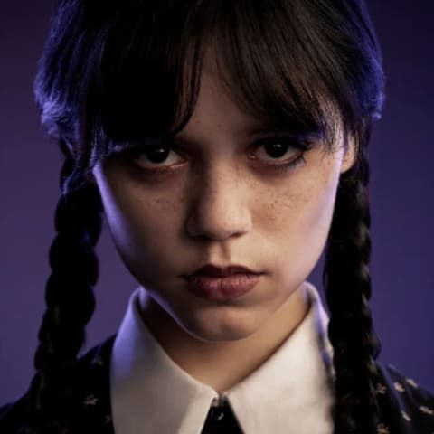 a woman with long braids wearing a shirt and tie