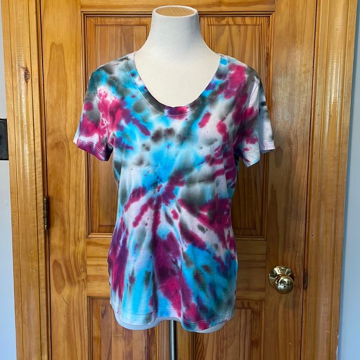 a woman's t - shirt on a mannequin stand in front of a wooden door