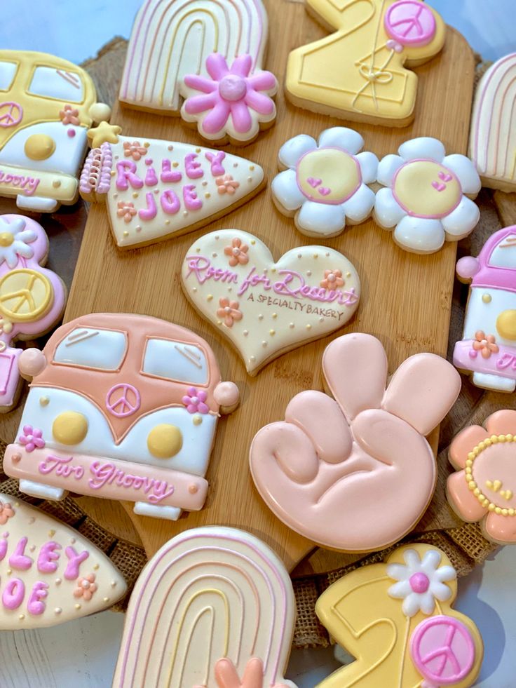 decorated cookies are arranged on a wooden board