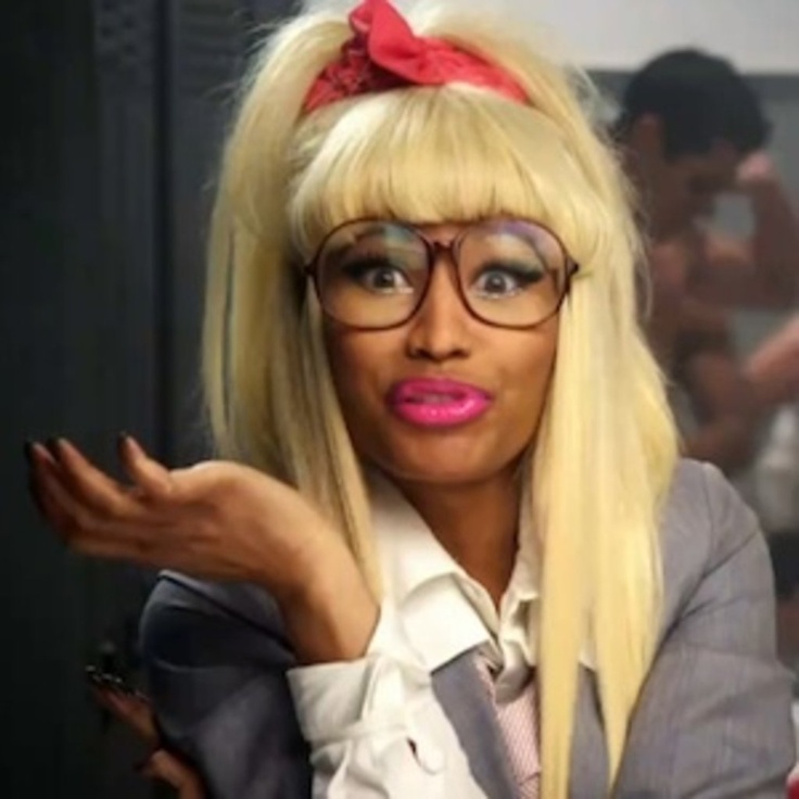 a woman with blonde hair wearing glasses and a pink bow in her hair is posing for the camera