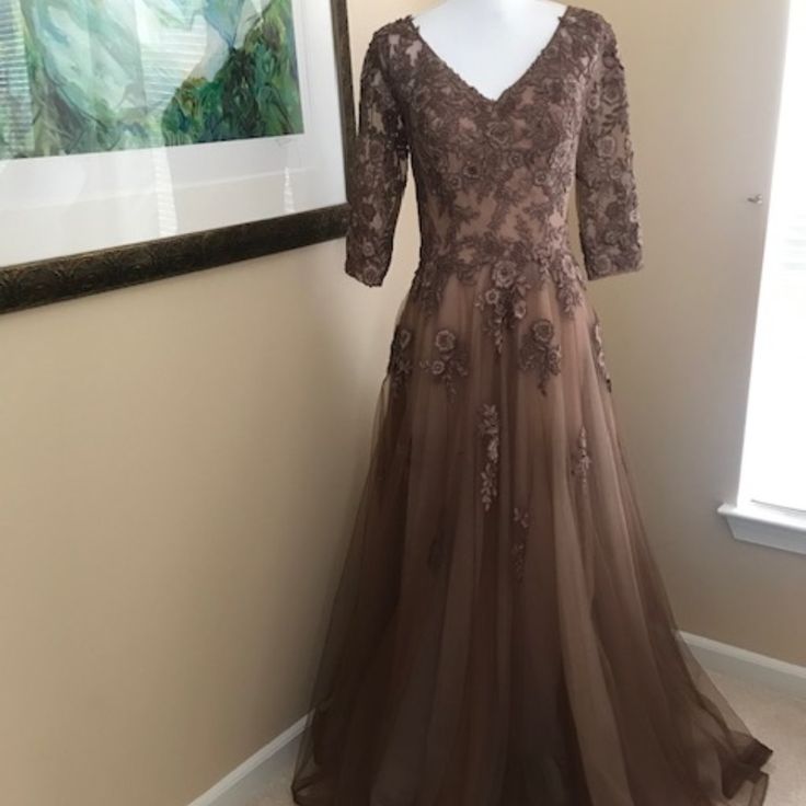 Beautiful, Flowing Cocoa Colored Gown For Any Special Occasion Delicately Embroidered Floral Pattern With Small Rhinestones For Glimmer Full Multi Layered Bottom Features: Deep V Neck, Hidden Back Zipper, Sheer Sleeve, Built In Bodice Support Size 6 Measures: 16" Underarm To Underarm, 30" Waist, 16" Sleeve From Shoulder 60" Long From Shoulder To Hem Embroidered Fitted A-line Evening Dress, Embroidered Fitted Ball Gown Evening Dress, Elegant Embroidered Ball Gown, Formal A-line Gown With Floral Embroidery, V-neck Embellished Gown For Mother Of The Bride, Embroidered Ball Gown Dresses For Formal Occasions, Fitted Embroidered Ball Gown, Floor-length Embroidered Evening Dress With Fitted Bodice, Embroidered Evening Dress With Fitted Bodice