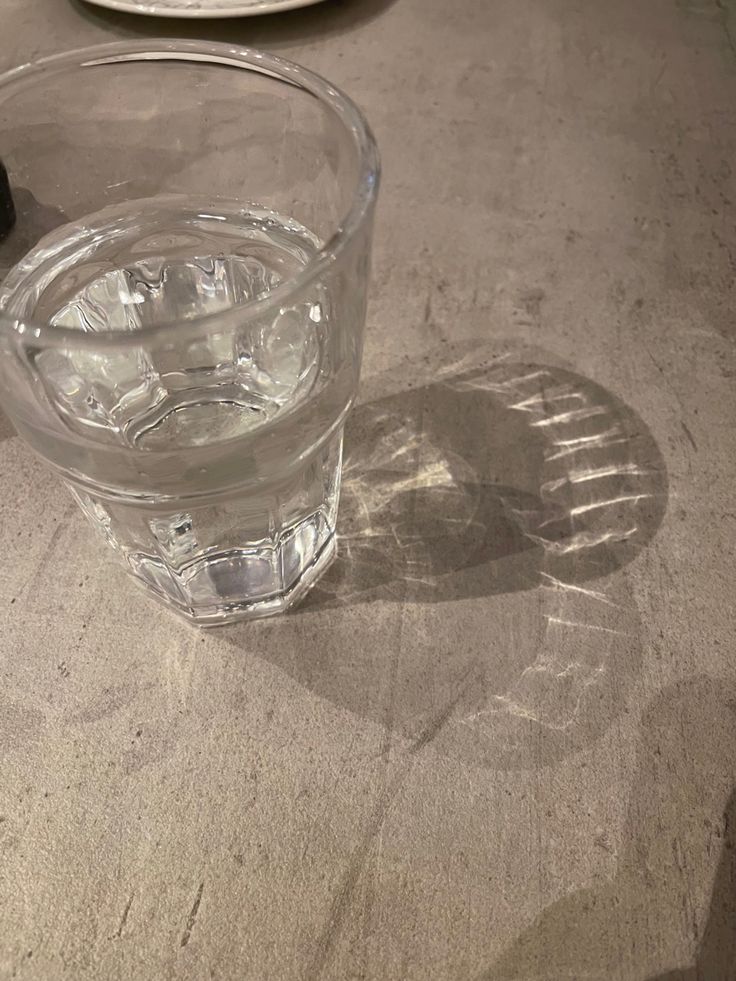 an empty glass sitting on top of a table