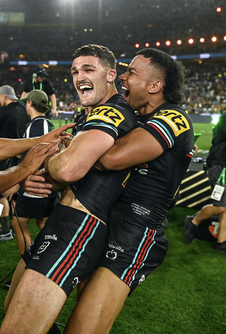 two rugby players are congratulating each other on the field