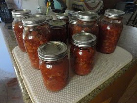 there are many jars full of food on the counter