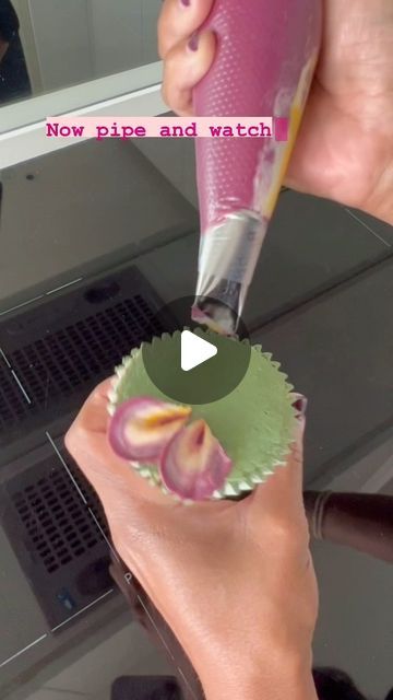 someone is using a pink cupcake to decorate their nails