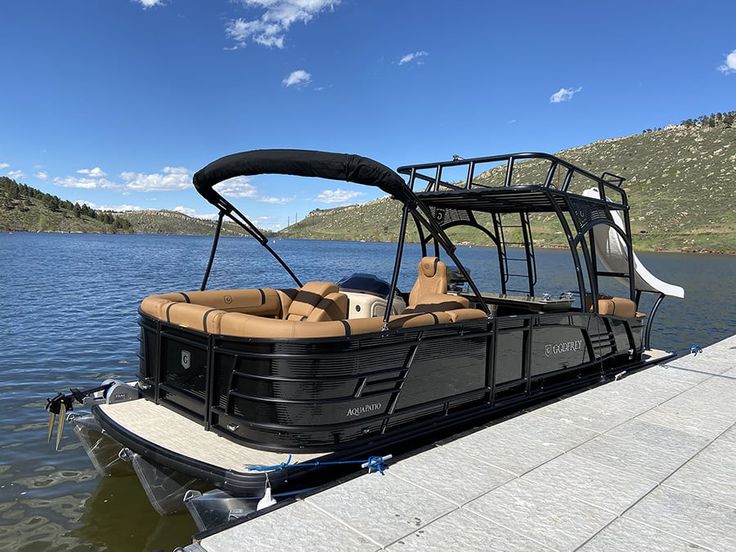 a pontoon boat is parked on the dock