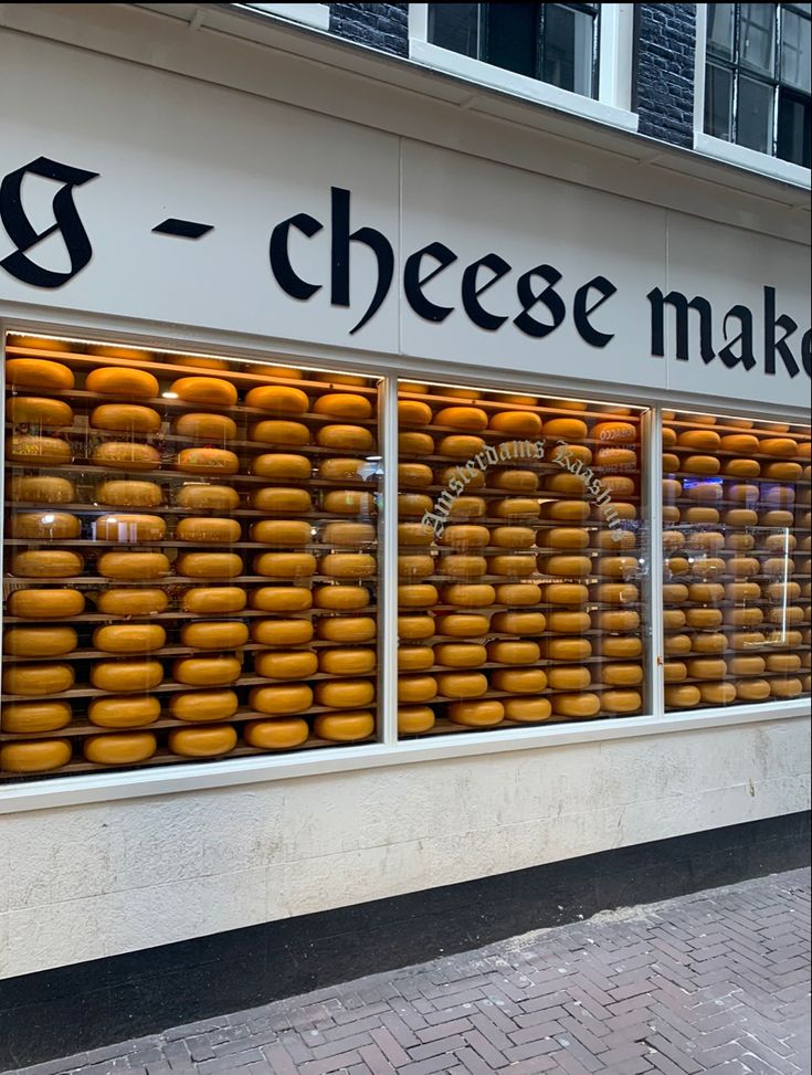 a store front with lots of cheese in the window