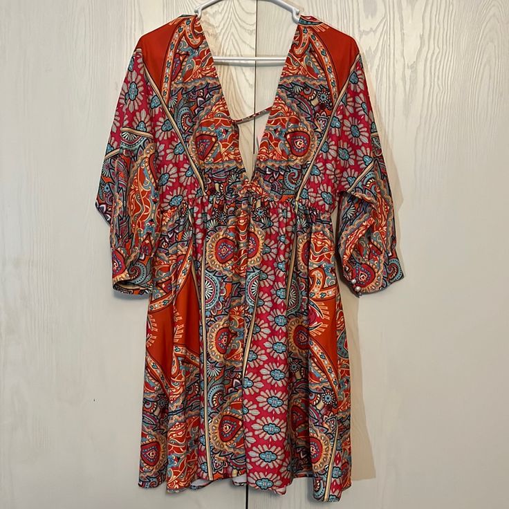 Nwt Boho Deep V Neck Dress Multi Color Paisley Print 3/4 Sleeves Elastic Empire Waist Tie Back Full Skirt 100% Polyester Unbranded Shoulder To Hem 34” Pit To Pit 21” Size L Stunning Colors! Beautiful! Multicolor Half Sleeve Dresses For The Beach, Flowy Orange Mini Dress For Beach, Orange Half Sleeve Summer Dress, Bohemian Mini Dress With Colorful Pattern For Beach, Orange Bohemian Mini Dress For Vacation, Bohemian Orange Mini Dress For Vacation, Bohemian V-neck Mini Dress With Vibrant Print, V-neck Mini Dress With Vibrant Print For Day Out, Flowy Orange Mini Dress For Vacation