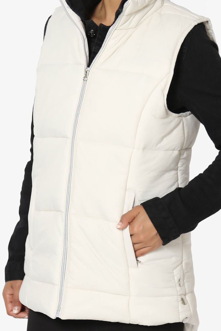 Padded vest is made from quilted matte nylon with warming fill. Perfect for the transitional months, it has zip pockets and side button details. Style this womens vest with a sports outfit, work attire, or everyday look. Perfect for throwing over long sleeve tops, sweaters, and lightweight coats.Funnel neck, Sleeveless, Front zipper closureSide zip pockets, Side button detailsHi low hem, Filled with insulating polyester, Padded designFits true to US size, S=Size(4-6), M=Size(8-10), L=Size(12-14) Nylon Workwear Vest, Sporty Winter Vest, Fitted Quilted Nylon Vest, Casual Nylon Vest For Workwear, Nylon Work Vest For Fall, Casual Nylon Quilted Jacket For Work, Winter Nylon Vest With Zipper Closure, Nylon Vest With Zipper Closure For Fall, Nylon Vest With Zipper Closure For Winter