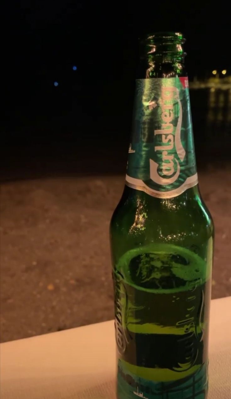 a green bottle sitting on top of a table