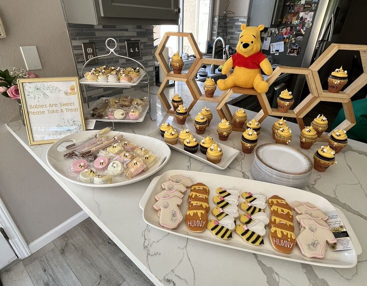 winnie the pooh birthday party with cupcakes, cookies and honeycombs