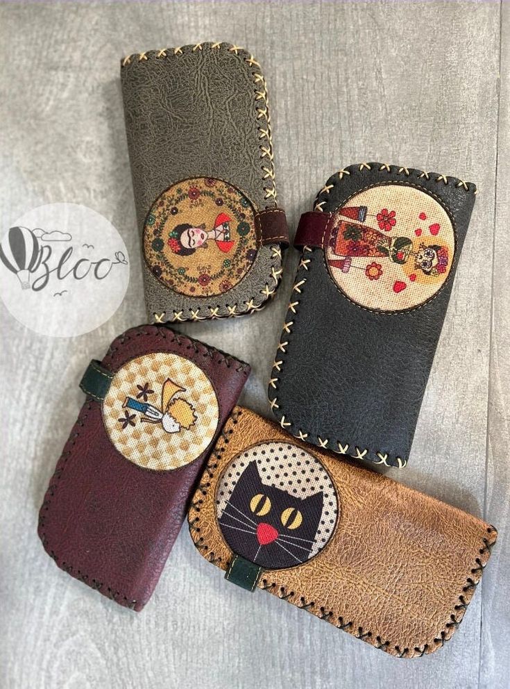 four small wallets with different designs on them