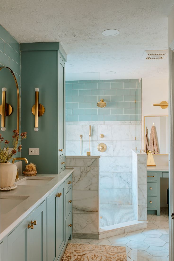 a bathroom with marble counter tops and blue walls