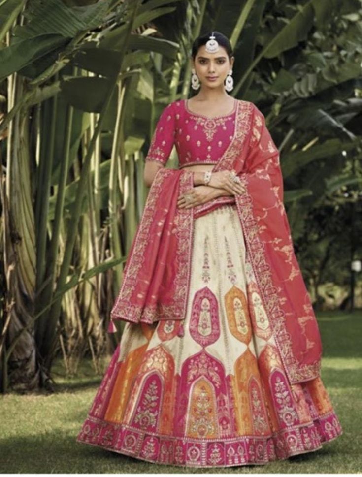 if you want to reduce the blouse size to 32,  then please add on customization with your purchase by going under the section - CUSTOMIZE BLOUSE SIZE Embroidered Banarsi Art Silk Jacquard Lehenga  This attire is Enhanced with Resham, Zari, Sequins, Stone and Lace Work Fully stitched Art Silk Choli in Pink and an Art Silk Dupatta in Peach. Crafted in Sweetheart Neck and Half Sleeve Fully stitched Lehenga  and Its Length is 41 inches Fully Stitched Blouse 34-40 size (Made in tailorsuch an intelligent way that customers can extend up to 40 inches by themselves (no tailors help is required) Jacquard Lehenga, Silk Bridal Lehenga, Stitched Lehenga, Silk Dupatta, Sweetheart Neck, Bridal Lehenga, Dress Clothes For Women, Half Sleeve, Half Sleeves