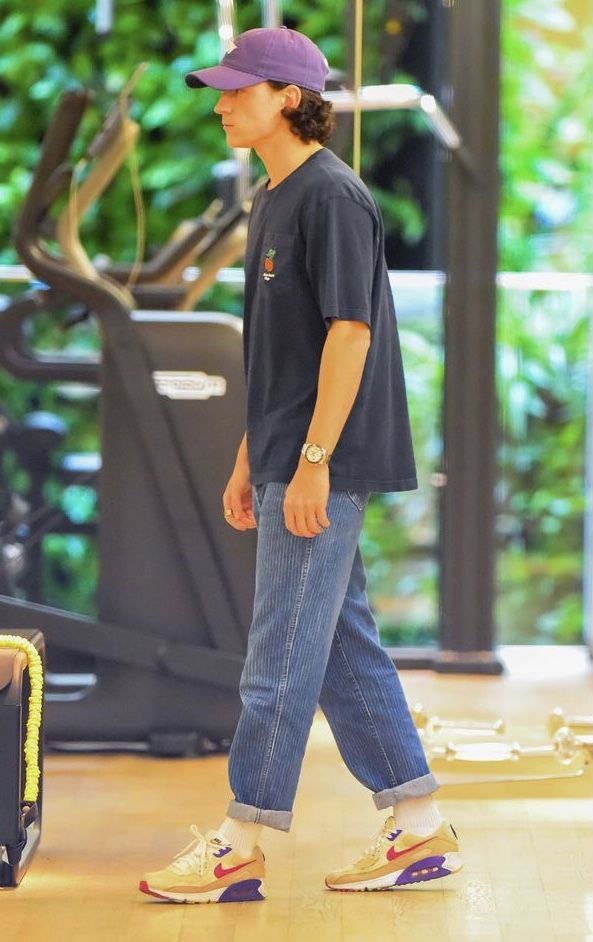 a young man is walking through the gym