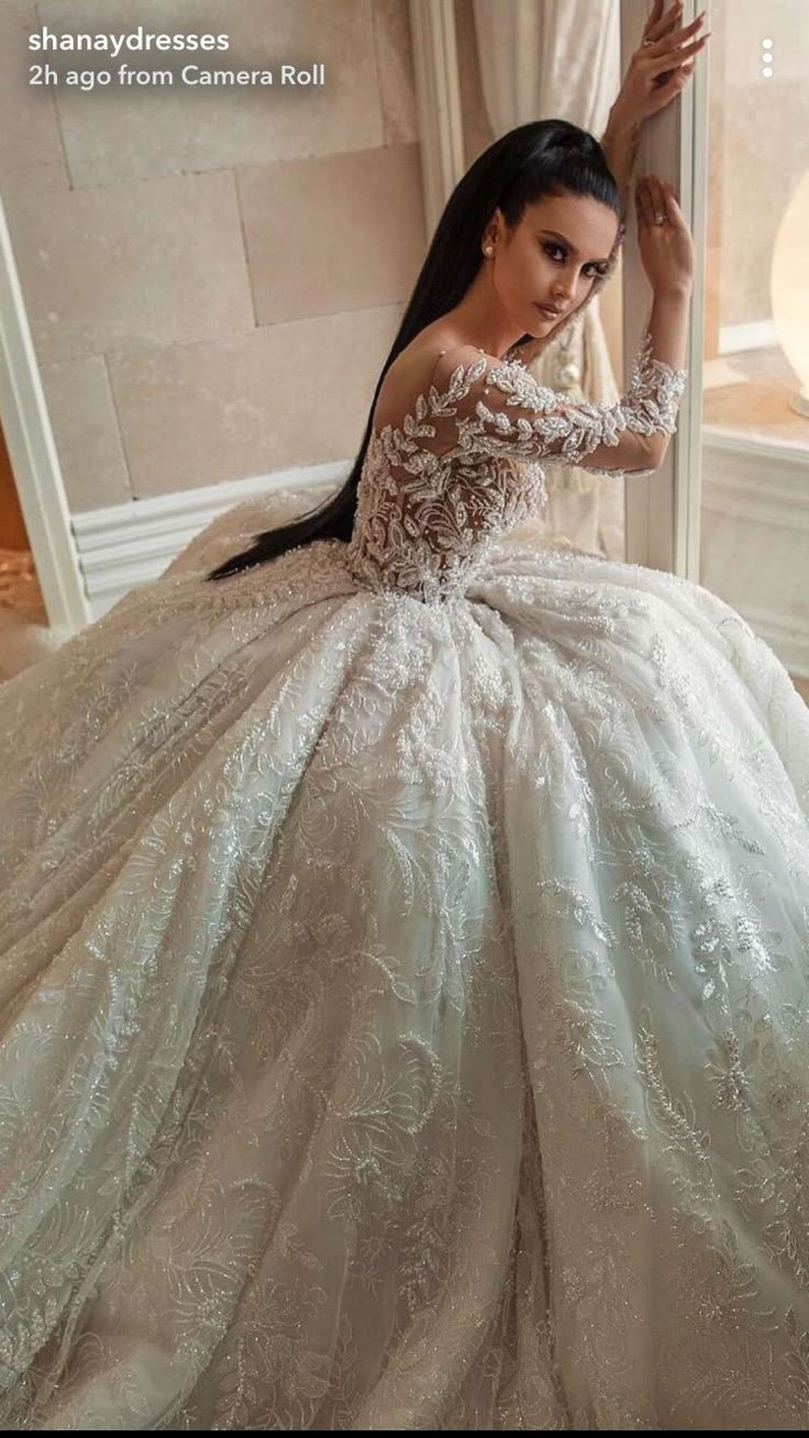 a woman in a wedding dress is posing for the camera