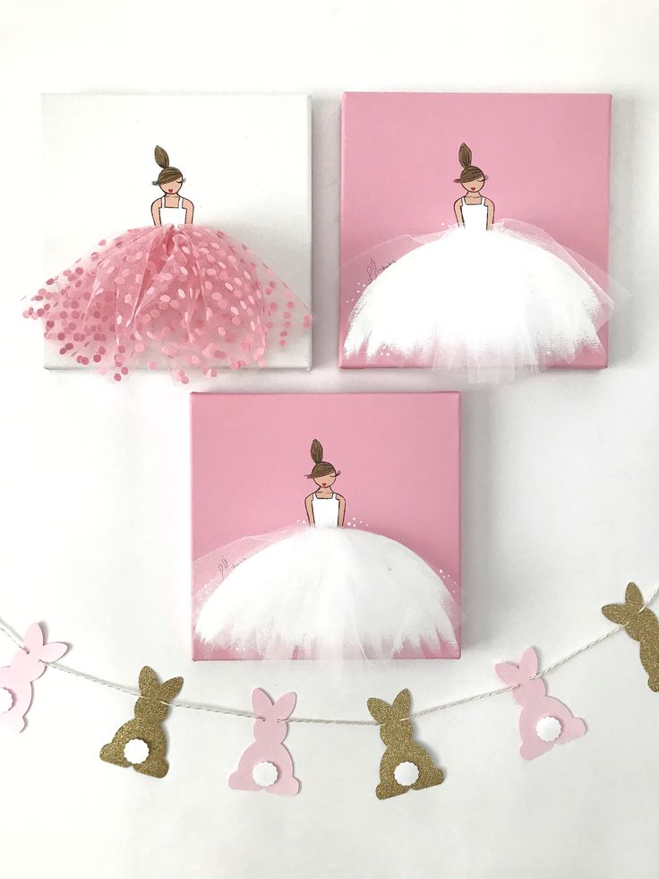 three pink and white cards with bunny bunnies hanging from the string, one in front of