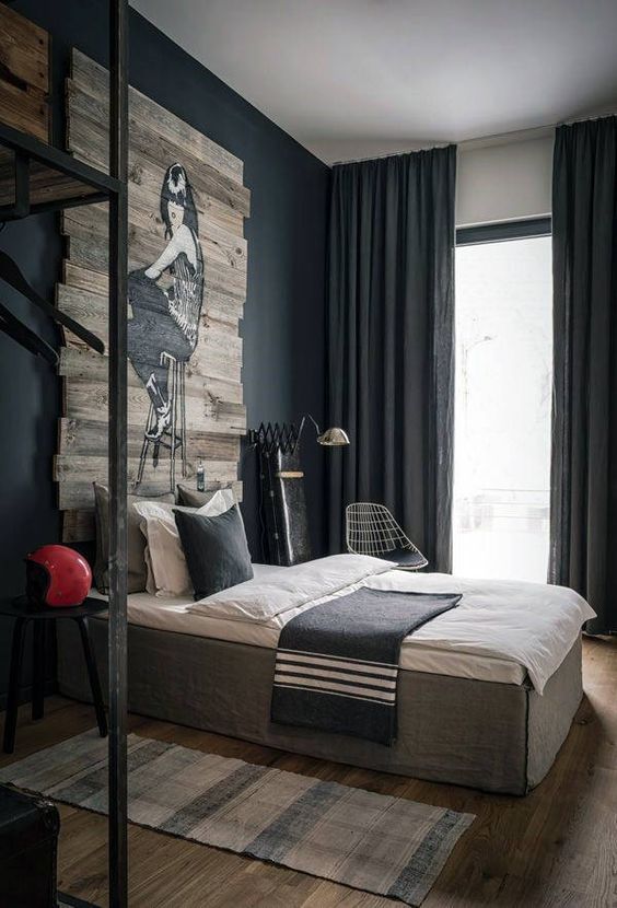 a large bed sitting in the middle of a living room next to a wooden wall