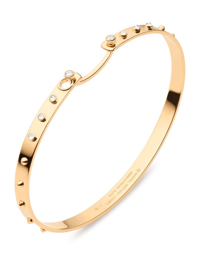 DETAILS With inverse diamonds and gold spikes, this Mood Bangle has a subtle edgy look that reminds us of the fun of New York City. The Brunch in New York Mood Bangle is made in 18k gold and in an oval shape, which makes it comfortable to wear every day. This bangle from the Mood Collection will stack seamlessly with any other bracelets. Collection: Mood Material: 18-Karat Gold Diamond Quality: F-G VS Carat Total Weight: 0.15 Measurements: 4 mm wide Clasp: Pinch sides to unhook the latch MATERIALS AND CARE Clean your diamond and gold pieces gently with a soft dry cloth. If the gold is stained, use warm water and diluted hand soap to gently rub off any marks. Avoid cleaning pearls and other gemstones with water and soap. Diamonds Collection, Rose Gold Bangle Bracelet, 18k Gold Bangle, Bracelets Collection, Heritage Jewellery, Rose Gold Bangle, French Jewelry, Bangle Ring, Gold Bangle Bracelet