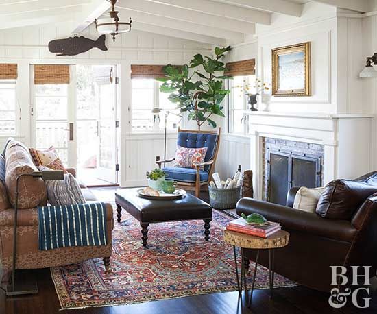 a living room filled with furniture and a fire place in the middle of a room