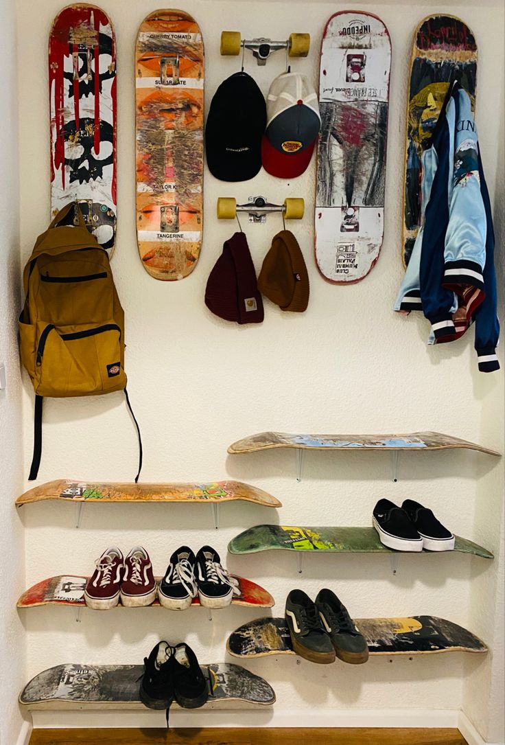 several skateboards and shoes are hanging on the wall