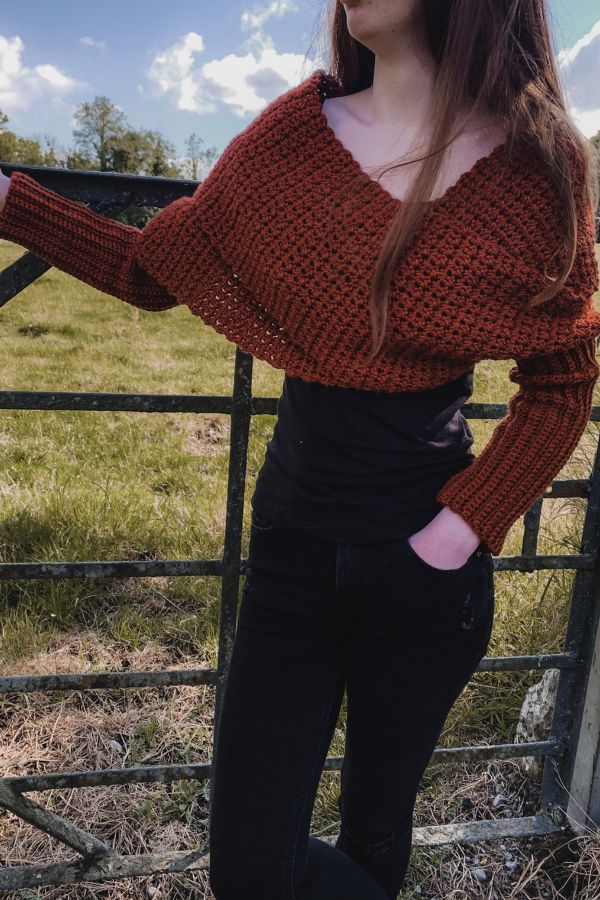 a woman standing in front of a fence