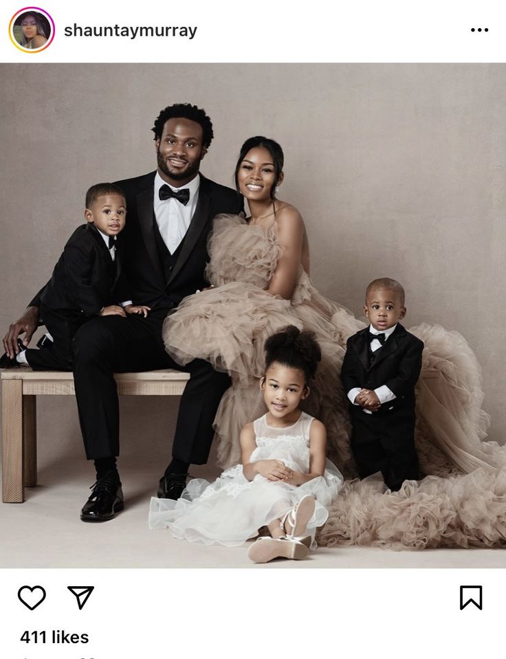 an image of a family posing for a photo in formal wear and tuxedos