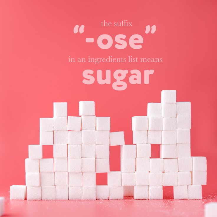 sugar cubes stacked on top of each other in front of a pink background that says, the sulfix lose in an ingredients list means sugar