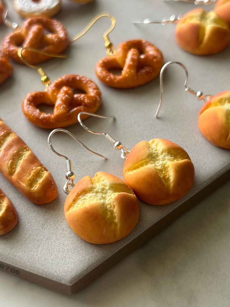 there are many different types of pastries on the trays, including buns and pretzels