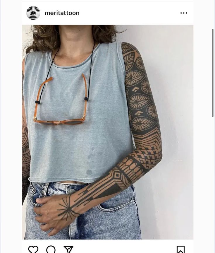 a woman with tattoos on her arms and arm is shown in an instagramture