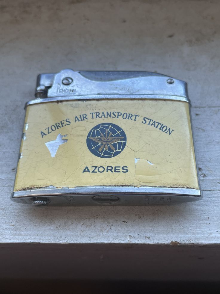 an old brass colored ziplock with the name azores air transport station on it