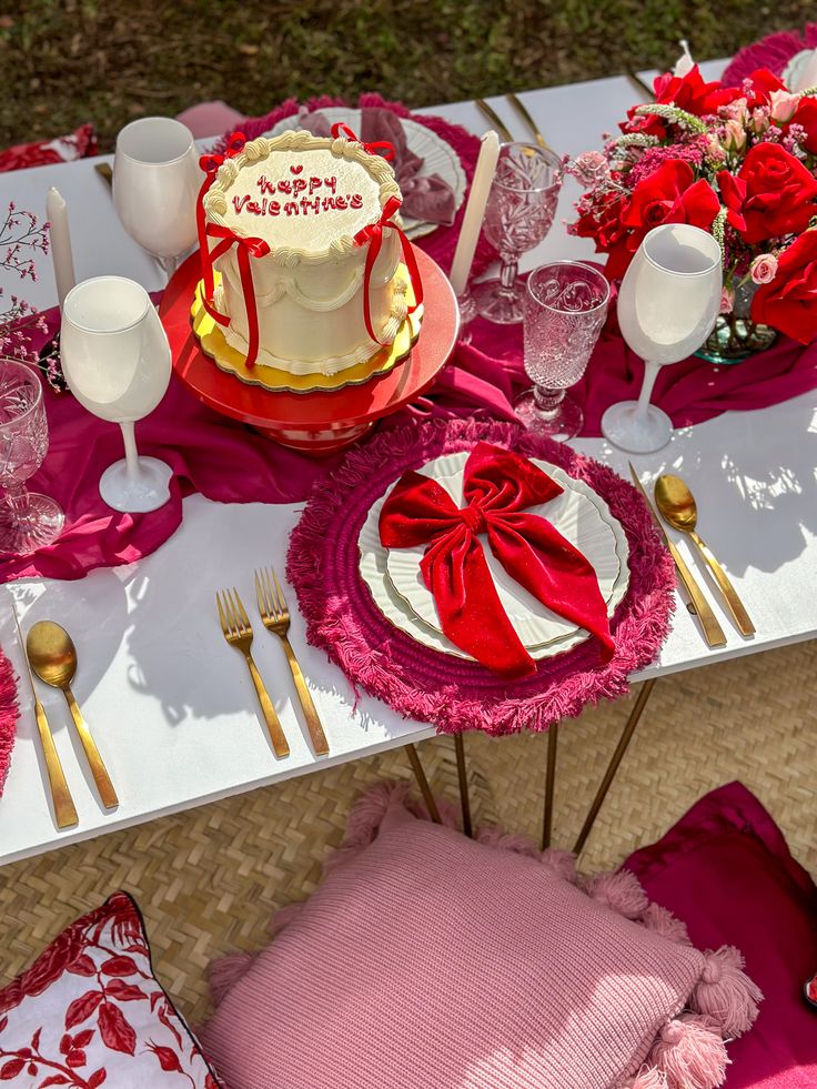 the table is set with pink and red decorations