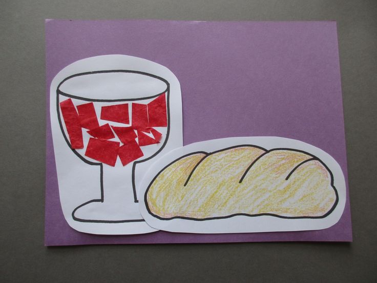 a piece of paper that has been cut out to look like bread and a glass of wine