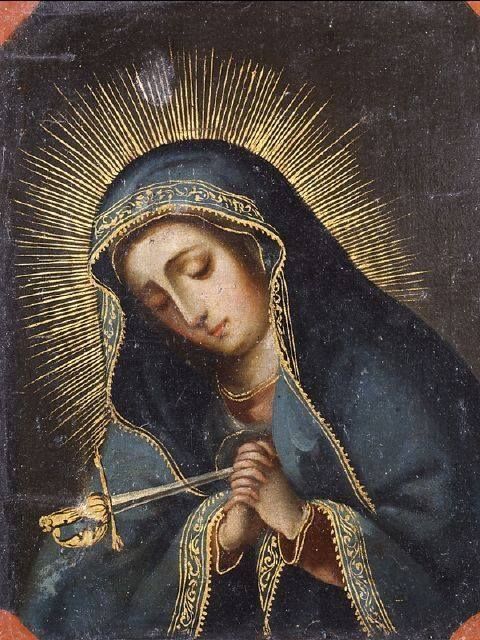 an image of the virgin mary holding a crucifix in her hands and looking down