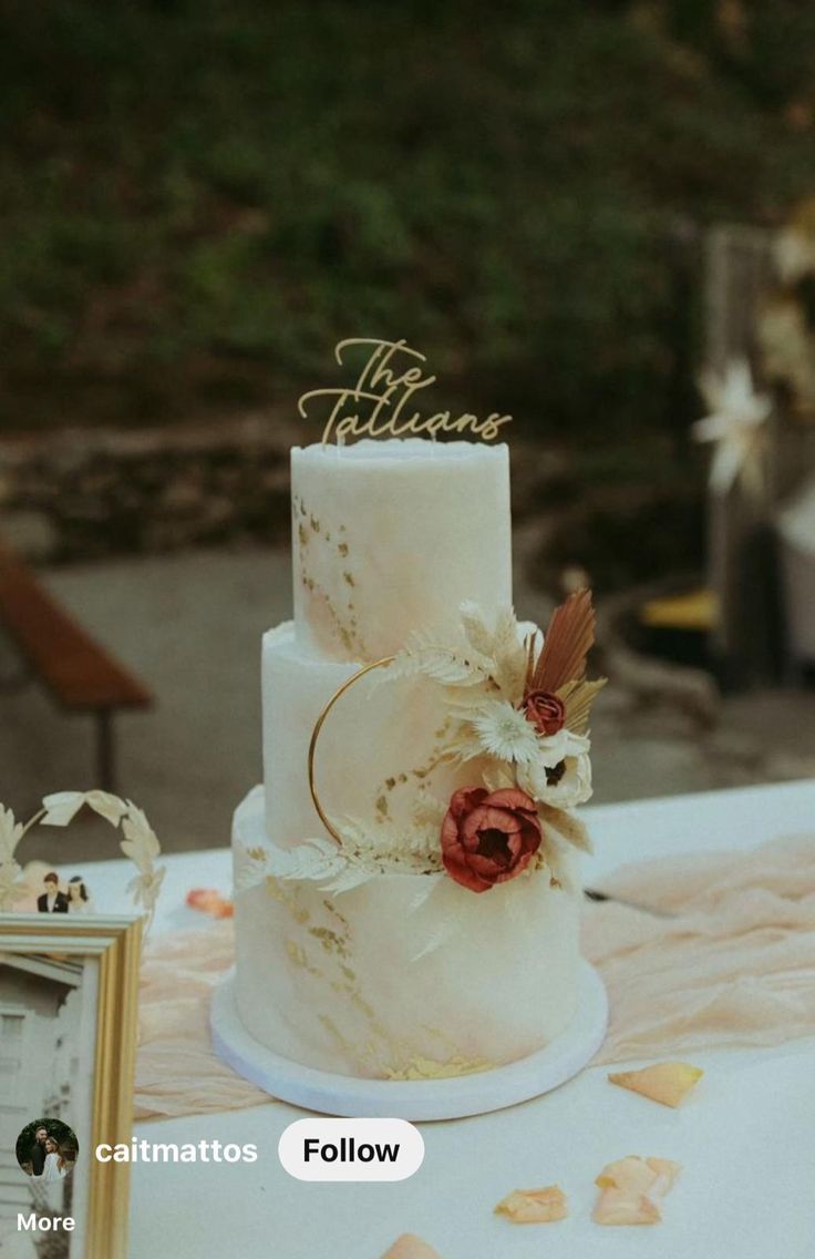 a three tiered wedding cake sitting on top of a table