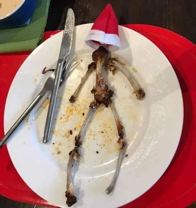 a white plate topped with food on top of a red and white place mat next to silverware